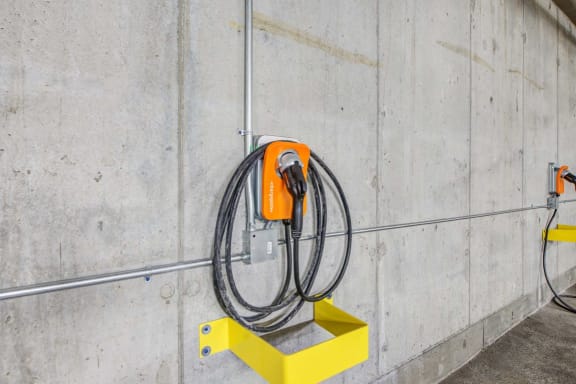 an electric hose attached to a hook on a wall