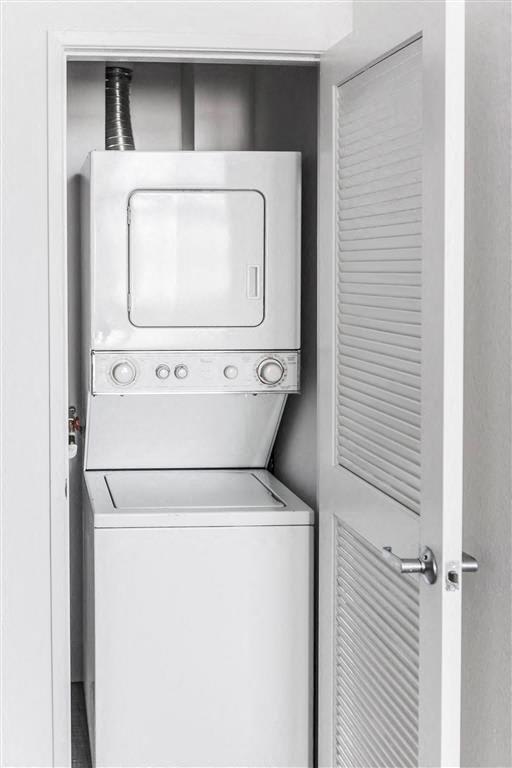 a refrigerator and a washing machine in a closet