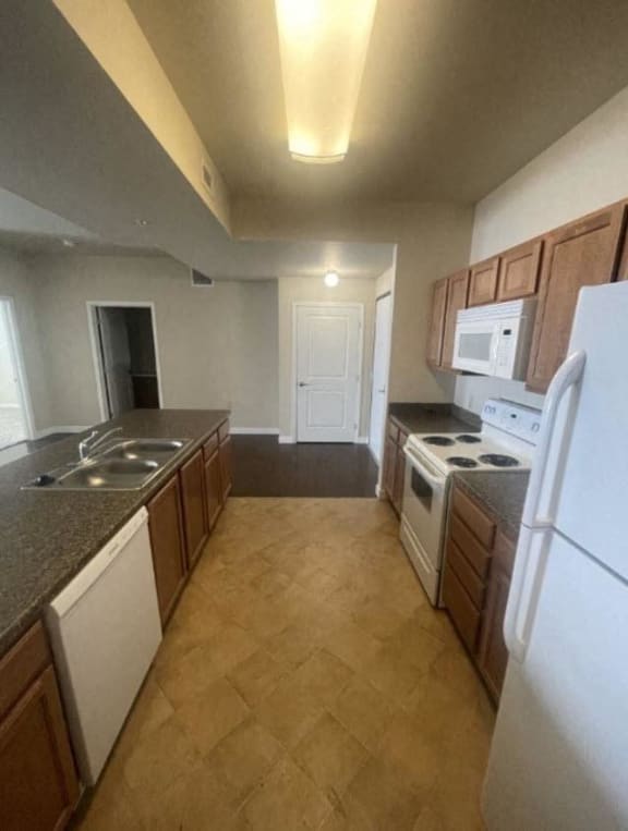 a kitchen with a stove refrigerator and a sink