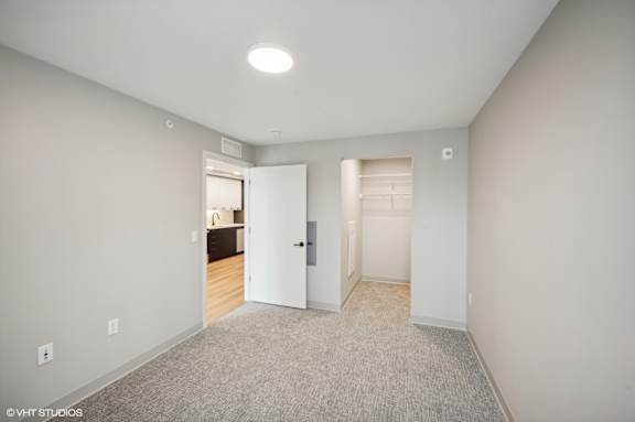 a bedroom with a closet and a door to a bathroom