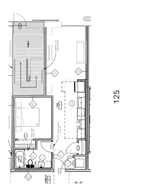 A floor plan of a building with a kitchen, living room, and bathrooms.