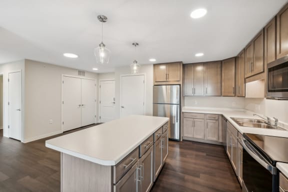 a kitchen with wooden cabinets and a white counter top