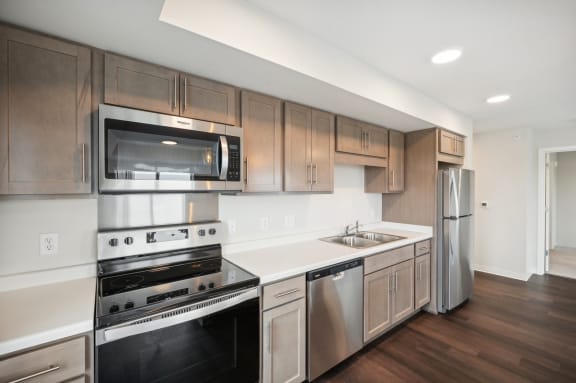 a kitchen with stainless steel appliances and wooden cabinets