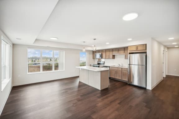 the preserve at ballantyne commons spacious living room and kitchen with stainless steel appliances
