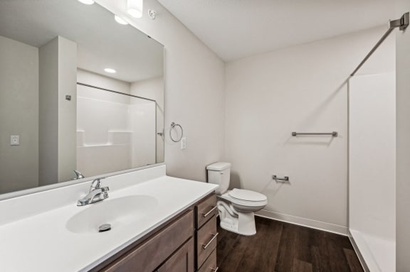 a bathroom with a large mirror and a toilet and sink