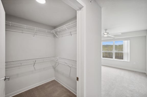 an empty room with white walls and a window