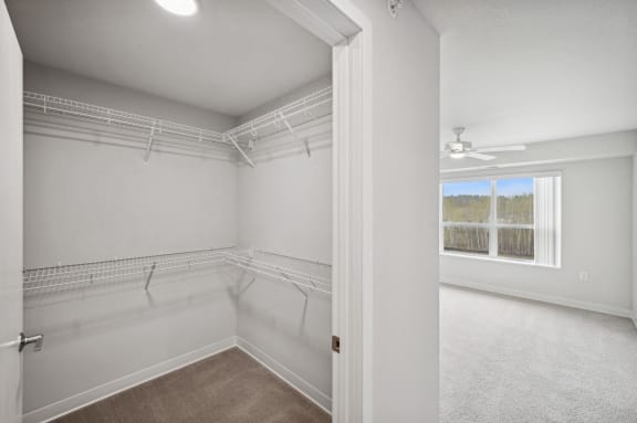 an empty room with white walls and a window
