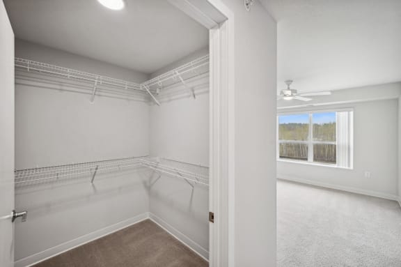 an empty room with white walls and a window