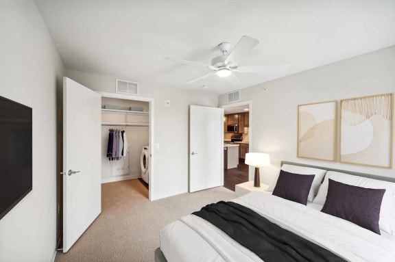 a bedroom with a bed and a ceiling fan