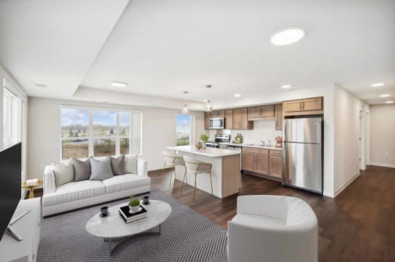 a living room and kitchen with a couch and a table