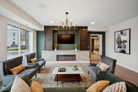 a living room with couches and chairs and a fireplace