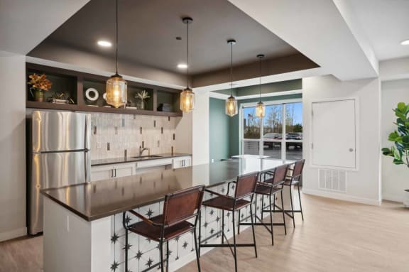 a large kitchen with a long island with chairs