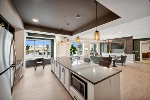 a large kitchen with a center island and a living room