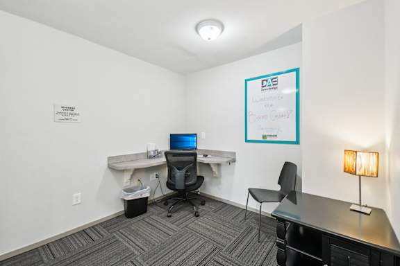 Community clubhouse with coworking lounge at Drawbridge Apartments in Harrison Township, MI.
