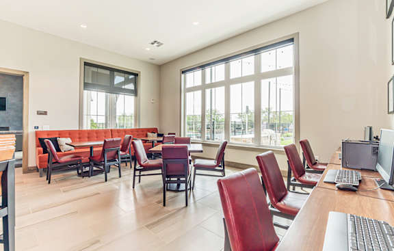 Clubhouse area with table chair and couch at Crossroad Commons Apartments, Texas, 78653