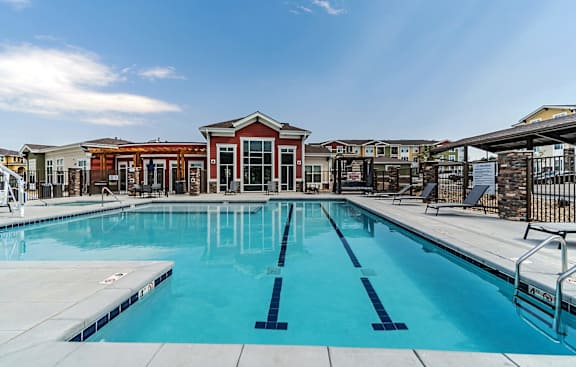 A large swimming pool with a building in the background.