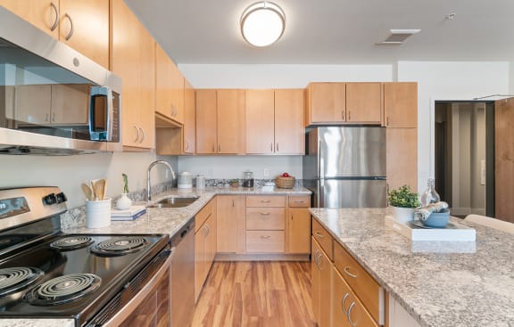 Granite Counter Tops In Kitchen at Harbor at Twin Lakes 55&#x2B; Apartments, Roseville, Minnesota
