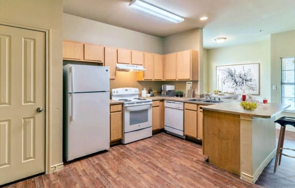 Kitchen with wood cabinets and white appliances3&#xA0;at Highland Hills, Dallas, TX, 75241