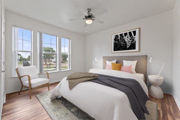 a bedroom with a large bed and a ceiling fan at Sandy Creek Apartments, Texas