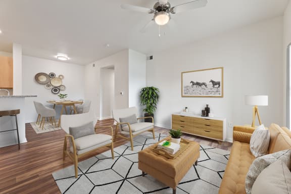an open living room and dining room with a ceiling fan at Sandy Creek Apartments, Bryan