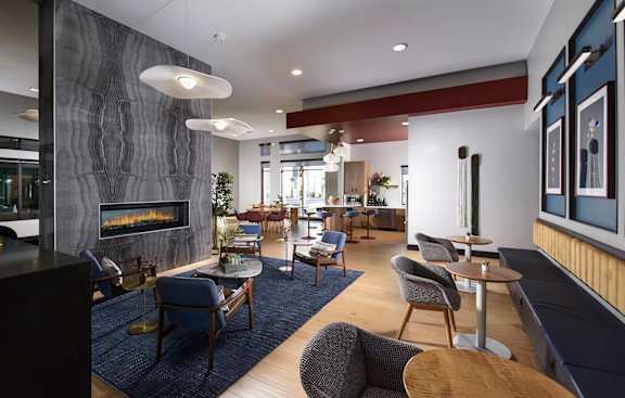 A modern living room with a fireplace and comfortable seating.