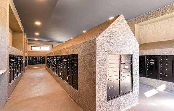A long hallway with a series of lockers on the wall.