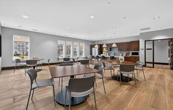 A modern dining area with wooden tables and chairs.