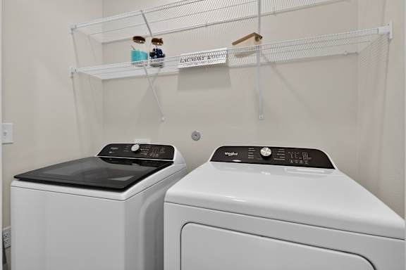 Two front loading washing machines in a laundry room.