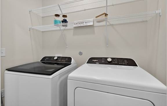 Two front loading washing machines in a laundry room.