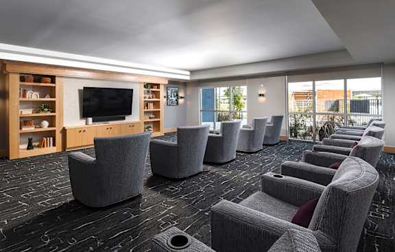 a large room with chairs and a tv in it