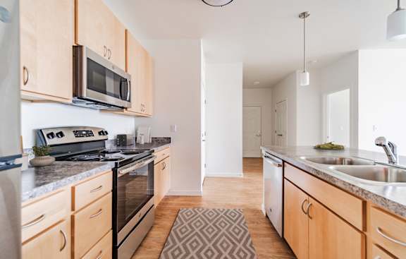 A kitchen with wooden cabinets and a granite countertop.