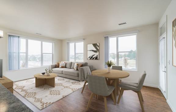 A living room with a grey couch, a wooden coffee table, and a rug.