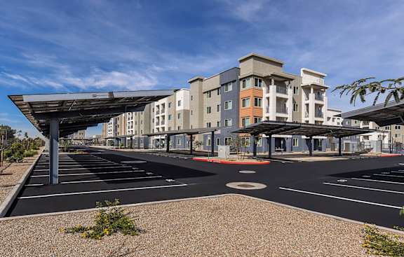 A parking lot with a large building in the background.