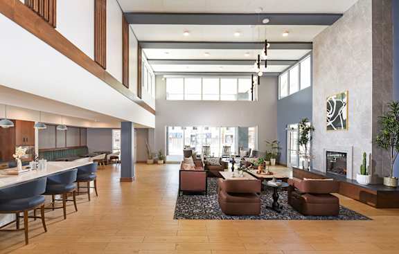 A large, modern living room with a fireplace and a dining area.