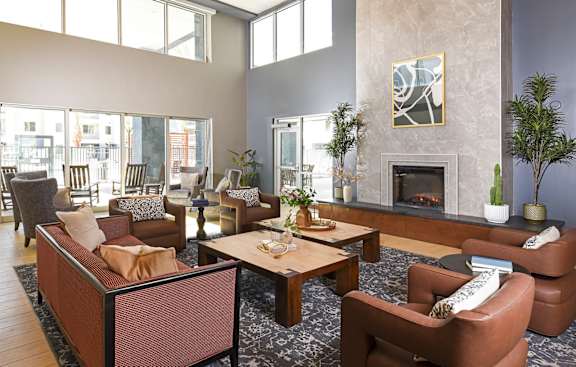 A living room with a fireplace and a painting on the wall.