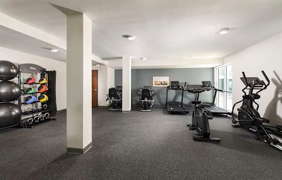 A spacious gym with a variety of exercise equipment.
