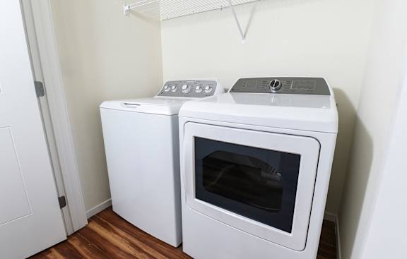 Two white ovens in a small kitchen.