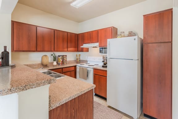 a kitchen with white appliances and granite counter tops&#xA0;at Lakeside Pointe Apartments &amp; Townhomes, Texas