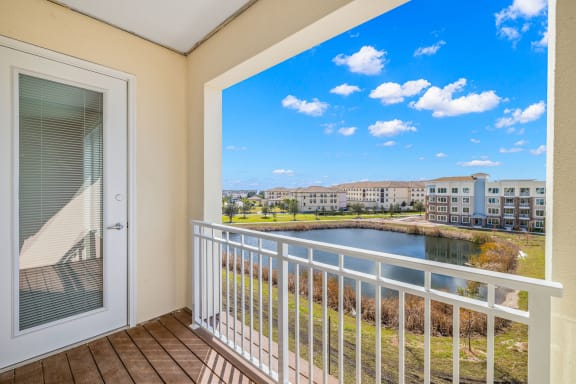 a balcony with a view of a lake and some buildings  at Osprey Park 62&#x2B; Apartments &amp; Cottages, Kissimmee, FL, 34758