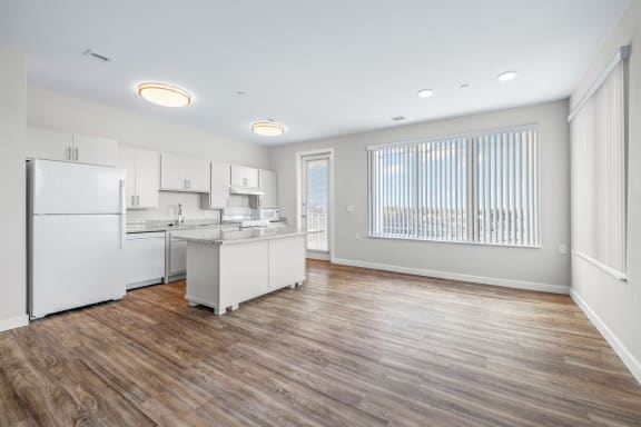 a white kitchen with a large window and a white refrigerator at Osprey Park 62&#x2B; Apartments, Kissimmee, 34758