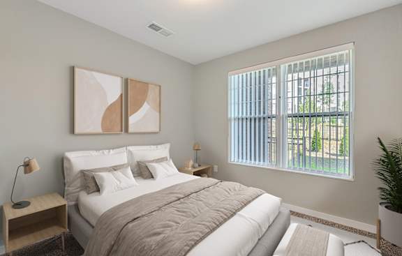 a bedroom with a large bed and a window