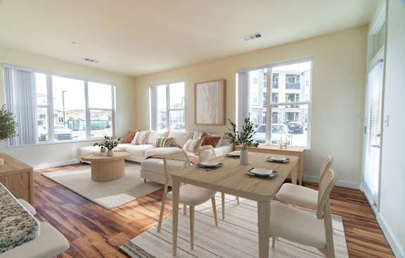 A dining room with a wooden table and chairs.