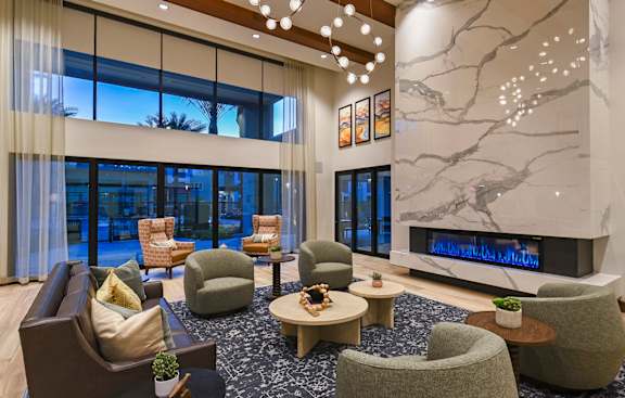 A modern living room with a fireplace and comfortable seating.