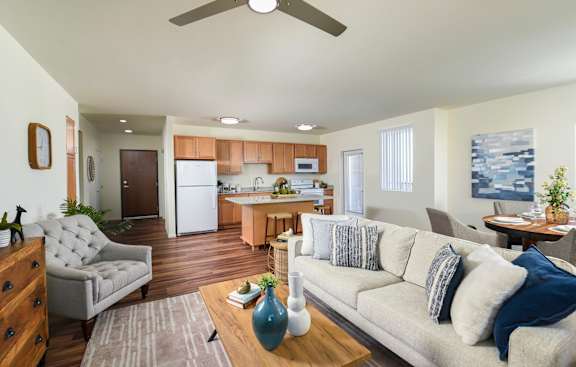 A modern living room with a grey couch and a wooden coffee table.