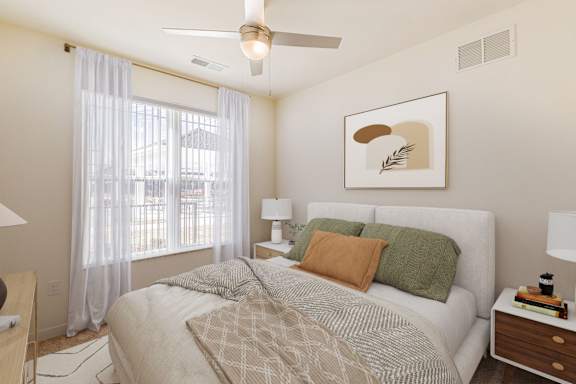 A bedroom with a bed, nightstands, and a ceiling fan.