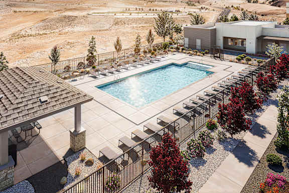 A pool surrounded by trees and a building in the background.