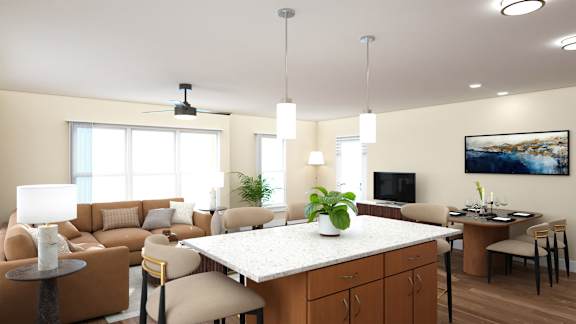 A well-lit living room with a large sectional sofa, a coffee table, and a kitchenette area.