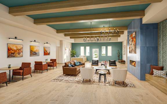Community gathering room with fireplace and seating areas at Vivir at Ballpark Village Apartments, Goodyear, 85338