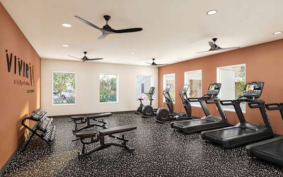 Fully equipped fitness room with cardio machines at Vivir at Ballpark Village Apartments, Goodyear