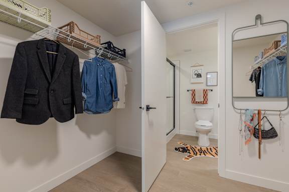 A white bathroom with a toilet and a mirror.